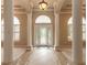 Grand foyer with high ceilings, columns, tile floors and an arched window above the front door at 15 Cambridge Trce, Ormond Beach, FL 32174