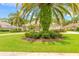 Beautiful home with circular driveway, lush landscaping, and mature palm trees at 15 Cambridge Trce, Ormond Beach, FL 32174