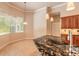 Bright kitchen showcasing granite countertops, a stylish sink, and a bay window with backyard views at 15 Cambridge Trce, Ormond Beach, FL 32174