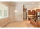 Elegant kitchen featuring wood cabinets, a granite island, a window, and pendant lighting at 15 Cambridge Trce, Ormond Beach, FL 32174