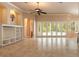 Open-concept living room featuring tile floors, built-in shelving, and expansive glass doors to the pool area at 15 Cambridge Trce, Ormond Beach, FL 32174