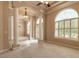 Bright living room with pillars, archways, and large windows, showcasing an open and airy design at 15 Cambridge Trce, Ormond Beach, FL 32174