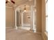 Open living room featuring decorative pillars, elegant chandeliers, and large windows for ample light at 15 Cambridge Trce, Ormond Beach, FL 32174