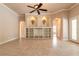 Spacious living room featuring custom built-ins, a ceiling fan, and decorative arched alcoves at 15 Cambridge Trce, Ormond Beach, FL 32174