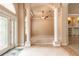 Spacious living room with neutral walls, tile floors, columns and large windows at 15 Cambridge Trce, Ormond Beach, FL 32174