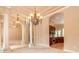 Inviting living area featuring decorative columns, elegant lighting, and an open flow to the kitchen at 15 Cambridge Trce, Ormond Beach, FL 32174