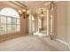 Bright living area with decorative columns, elegant lighting, and a view of the front entrance at 15 Cambridge Trce, Ormond Beach, FL 32174