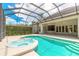 View of the screened pool and hot tub with clear blue skies at 15 Cambridge Trce, Ormond Beach, FL 32174