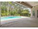 View of the screened in pool, hot tub and patio area at 15 Cambridge Trce, Ormond Beach, FL 32174
