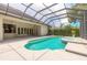 Backyard pool with hot tub surrounded by screened in enclosure at 15 Cambridge Trce, Ormond Beach, FL 32174