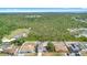 Aerial view of the home with neighboring houses in a verdant, heavily wooded area at 1561 Randolph St, Deltona, FL 32725