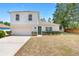 Charming two-story home with a well-maintained front yard, attached garage and manicured shrubs at 1561 Randolph St, Deltona, FL 32725
