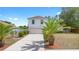 Two-story home with a driveway, garage, and palm trees for a Floridian feel at 1561 Randolph St, Deltona, FL 32725