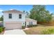 Two-story home with manicured front lawn, attached garage, and lovely curb appeal at 1561 Randolph St, Deltona, FL 32725