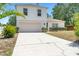 Bright two-story home with a manicured lawn, a two-car garage, and tidy landscaping at 1561 Randolph St, Deltona, FL 32725