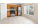 Bright eat-in kitchen featuring stainless steel appliances, granite counters, and tile flooring at 1561 Randolph St, Deltona, FL 32725