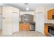 Kitchen area with wood cabinets, granite countertops, and an opening into the living room at 1561 Randolph St, Deltona, FL 32725