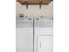 Laundry area featuring a washer and dryer set with overhead shelving at 1561 Randolph St, Deltona, FL 32725