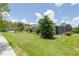 Expansive backyard with lush green lawn, mature landscaping, and screened-in patio at 1653 Victoria Gardens Dr, Deland, FL 32724