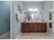 Bright bathroom featuring a double vanity, wood cabinetry, and a large mirror for added convenience at 1653 Victoria Gardens Dr, Deland, FL 32724