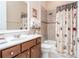 This bathroom features a modern vanity, toilet, bathtub, shower, and a decorative shower curtain at 1653 Victoria Gardens Dr, Deland, FL 32724