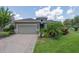 Charming single-story home boasts a well-manicured lawn and neutral colored exterior paint at 1653 Victoria Gardens Dr, Deland, FL 32724