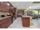 Spacious kitchen boasts stainless appliances, an island, and beautiful granite countertops at 1653 Victoria Gardens Dr, Deland, FL 32724