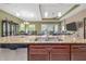 Close-up of kitchen island with stainless steel dishwasher, granite countertops, and ample storage at 1653 Victoria Gardens Dr, Deland, FL 32724