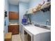 Functional laundry room featuring cabinetry, sink, shelving, washer, and dryer at 1653 Victoria Gardens Dr, Deland, FL 32724