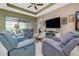 Inviting living area with a large TV, cozy seating, and access to the outdoor area at 1653 Victoria Gardens Dr, Deland, FL 32724