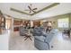 Open-concept living space with modern furniture, ceiling fan, and views of the kitchen at 1653 Victoria Gardens Dr, Deland, FL 32724