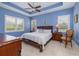Serene main bedroom with tray ceiling, neutral decor, and ample natural light from large windows at 1653 Victoria Gardens Dr, Deland, FL 32724