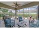 This screened-in patio offers comfortable seating, a ceiling fan, and a clear view of the backyard at 1653 Victoria Gardens Dr, Deland, FL 32724