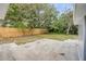 Fenced backyard with mature trees and concrete patio area at 173 Cedar Ave, Orange City, FL 32763
