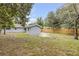 Spacious backyard featuring a shed, patio, and wooden fence, perfect for outdoor activities and privacy at 173 Cedar Ave, Orange City, FL 32763
