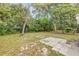 View of backyard with mature trees, fire pit and patio area at 173 Cedar Ave, Orange City, FL 32763