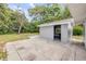 View of backyard, shed with workspace and concrete patio area at 173 Cedar Ave, Orange City, FL 32763