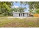 Backyard view with shed, patio and partial fence at 173 Cedar Ave, Orange City, FL 32763