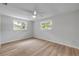 Light-filled bedroom with wood-look flooring, and two windows at 173 Cedar Ave, Orange City, FL 32763