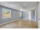 Bright bedroom with two windows, light blue walls, and a ceiling fan at 173 Cedar Ave, Orange City, FL 32763