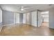 Bedroom featuring two doors, a ceiling fan, and view into the updated kitchen at 173 Cedar Ave, Orange City, FL 32763
