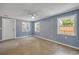 Bedroom boasts natural light, light blue walls, and three windows at 173 Cedar Ave, Orange City, FL 32763