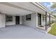 Spacious covered porch area featuring neutral paint, lighting, and access to the front door and side entrance at 173 Cedar Ave, Orange City, FL 32763