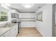 Well-lit kitchen featuring updated appliances, ample cabinetry, and a convenient passthrough to the living area at 173 Cedar Ave, Orange City, FL 32763