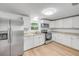 Updated kitchen featuring stainless steel appliances, ample counter space, and bright white cabinetry at 173 Cedar Ave, Orange City, FL 32763