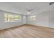 Sun-lit living room with new flooring and ample natural light, with views out to the front yard and neighborhood at 173 Cedar Ave, Orange City, FL 32763