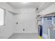 Utility room with painted floors, water heater, and shelving at 173 Cedar Ave, Orange City, FL 32763