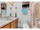 Bathroom featuring a vanity, toilet, bathtub with shower, and decorative towels at 1730 Birmingham Ave, Daytona Beach, FL 32117