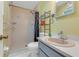 Bathroom with a walk-in shower, single sink vanity, and tile flooring at 1730 Birmingham Ave, Daytona Beach, FL 32117