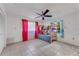 Bright bedroom featuring a bunk bed, a ceiling fan and vibrant curtains at 1730 Birmingham Ave, Daytona Beach, FL 32117
